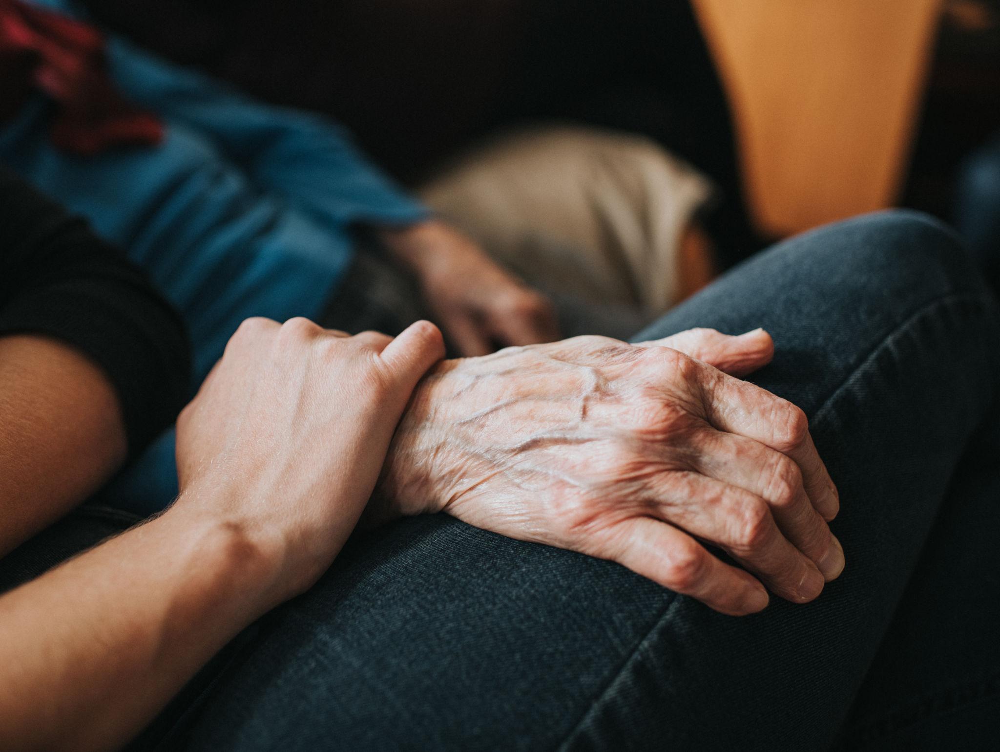 Two people sharing a quiet, comfortable moment together in a home setting