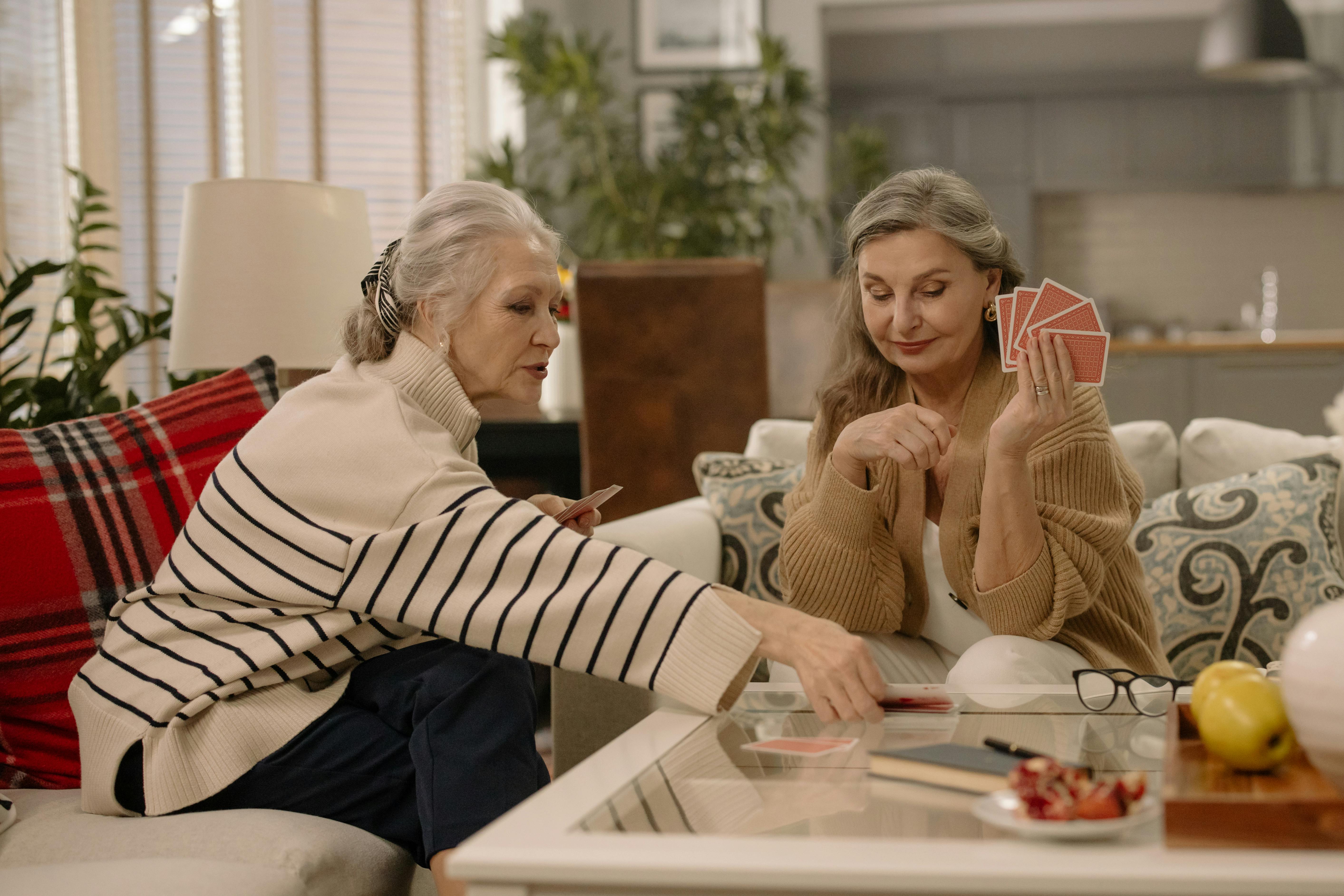 A companion and senior sharing a warm moment together, looking through memories