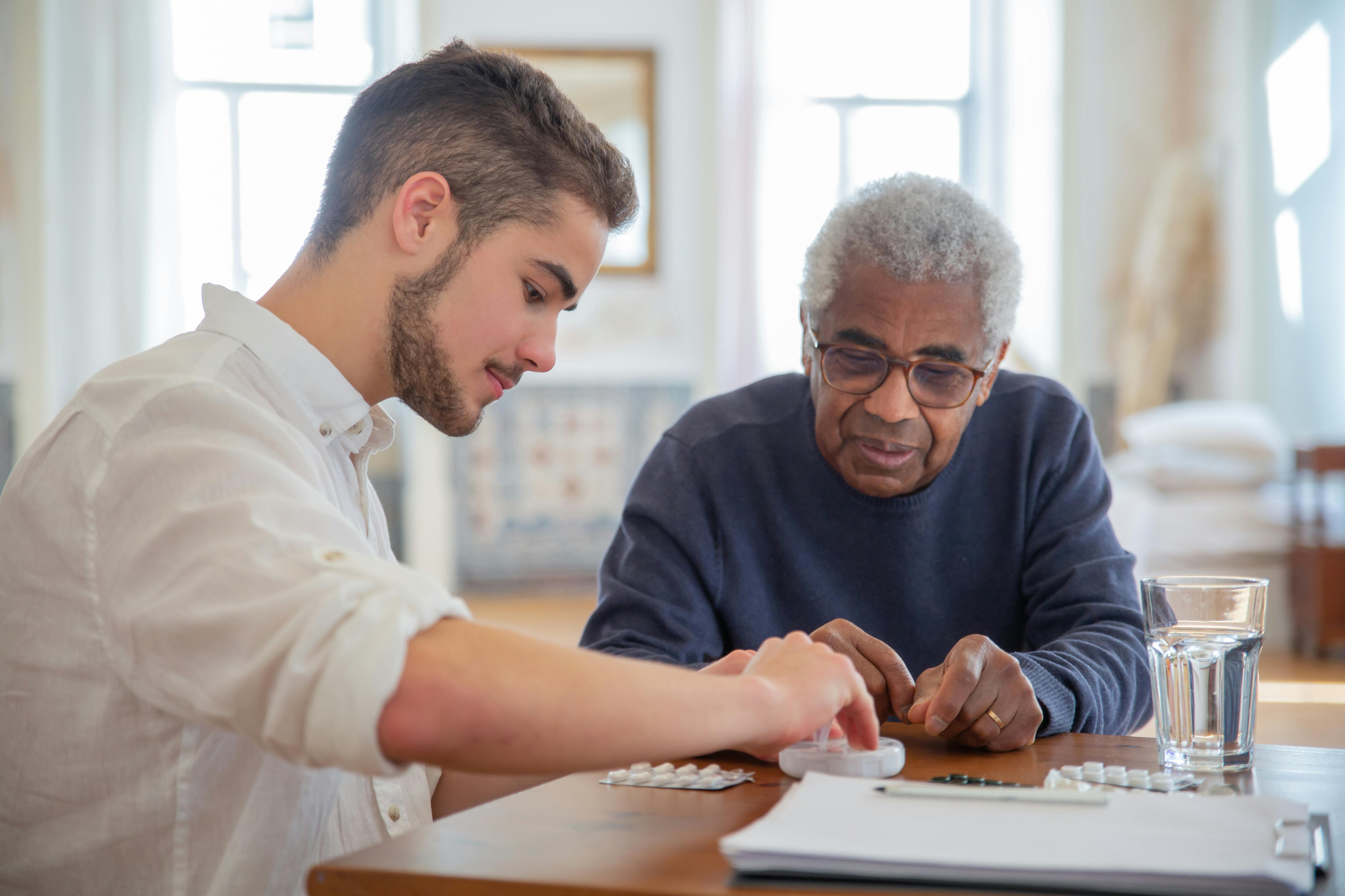 Two people sharing a quiet, unhurried conversation in a warm and welcoming home setting